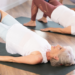Mature woman lifting pelvis off exercise mat