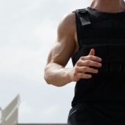 Man wearing weighted vest runs down a staircase