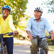 Mature couple riding bikes side by side