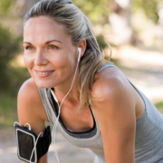 Mature woman pauses to stretch during a run