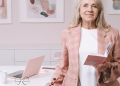 Female doctor standing in front of a desk in her office