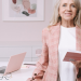 Female doctor standing in front of a desk in her office