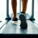 Close-up of a person's lower legs and sneakers walking on a treadmill