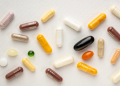 Vitamin supplement capsules and softgels on a white background