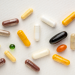 Vitamin supplement capsules and softgels on a white background