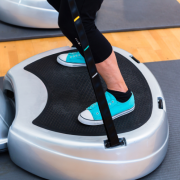 Woman on vibration plate at gym