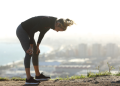 Female runner slumps over to rest