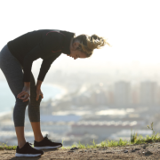 Female runner slumps over to rest