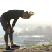 Female runner slumps over to rest