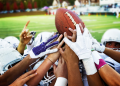 Football players fight to catch a football