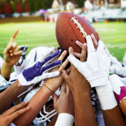 Football players fight to catch a football