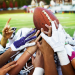Football players fight to catch a football