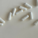 White capsules on a white background