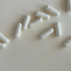 White capsules on a white background