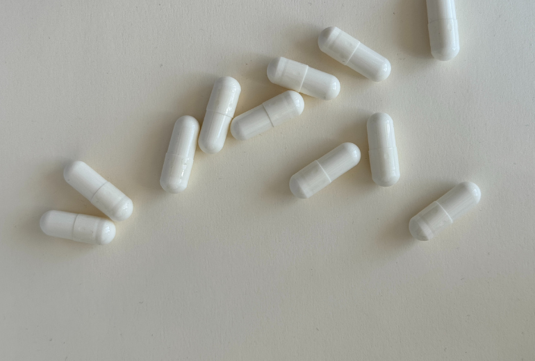 White capsules on a white background